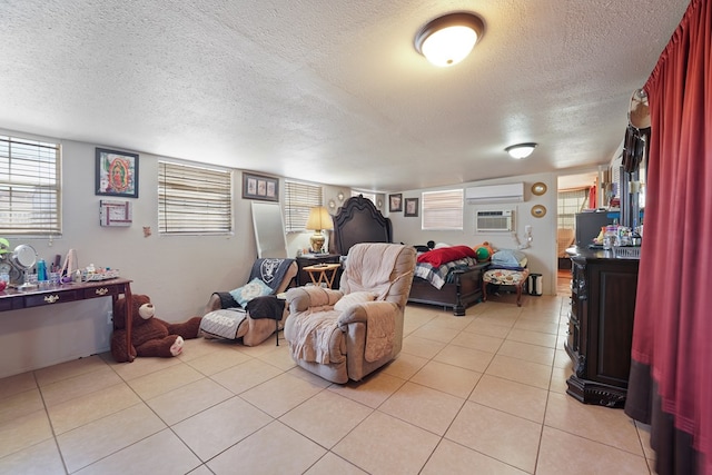 living area featuring light tile patterned floors, a textured ceiling, and an AC wall unit