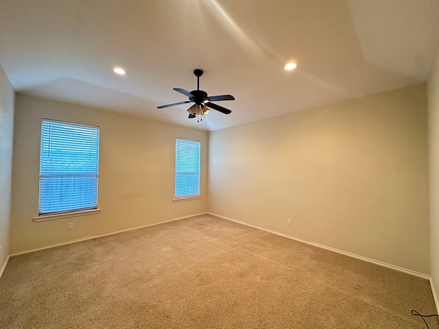 empty room featuring a ceiling fan, carpet flooring, a wealth of natural light, and recessed lighting