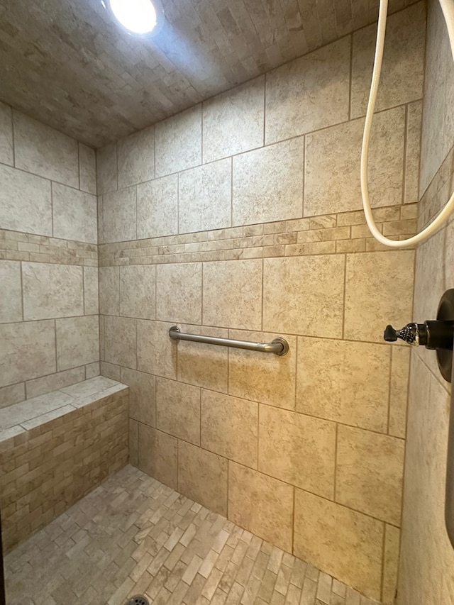 full bath with a tile shower