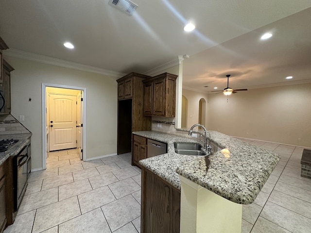 kitchen featuring visible vents, arched walkways, dishwasher, a peninsula, and a sink