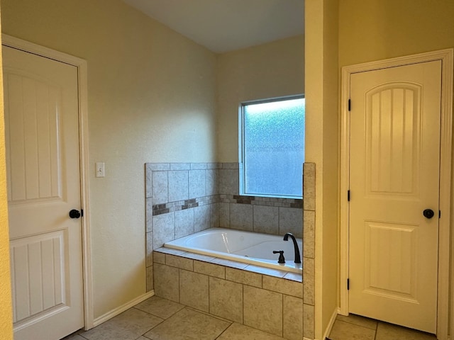 full bath featuring a garden tub and tile patterned floors