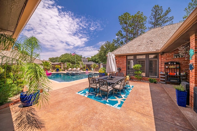 view of patio with outdoor dining area and an outdoor pool