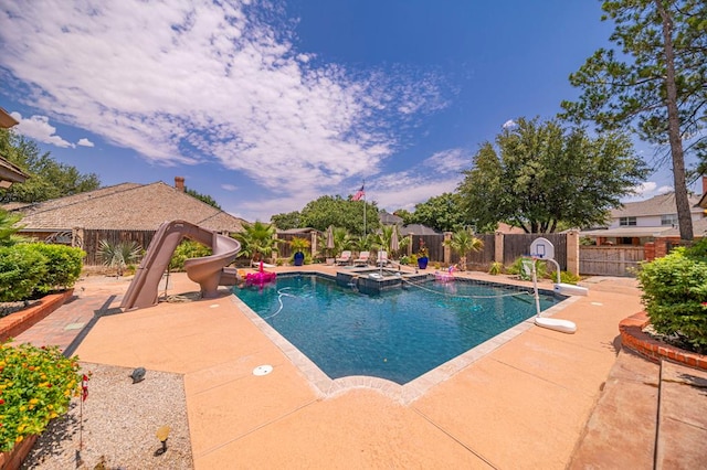 view of pool featuring a fenced in pool, a water slide, a patio area, and a fenced backyard