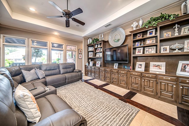 living area featuring visible vents, ceiling fan, ornamental molding, a tray ceiling, and recessed lighting