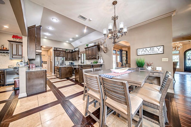 dining space featuring arched walkways, visible vents, and plenty of natural light