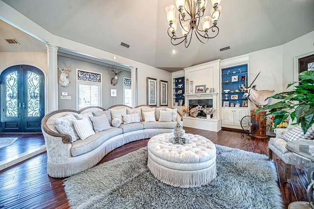 living area with a high end fireplace, french doors, visible vents, and wood-type flooring