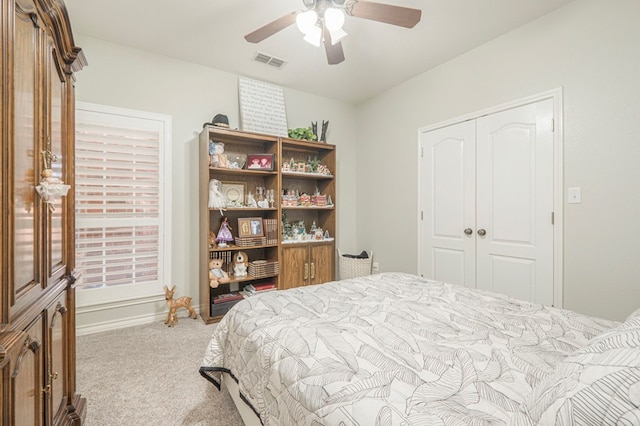 carpeted bedroom with ceiling fan and a closet