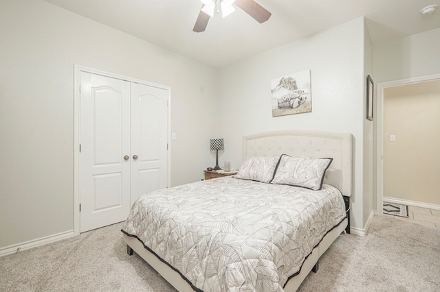 carpeted bedroom with ceiling fan and a closet