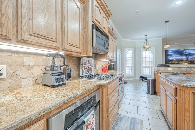 kitchen featuring appliances with stainless steel finishes, pendant lighting, backsplash, ornamental molding, and light stone counters