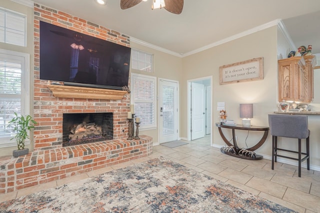 tiled living room with ornamental molding, ceiling fan, and a fireplace