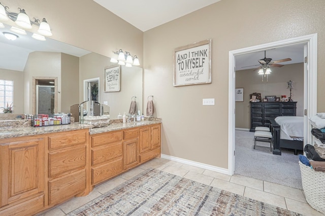 bathroom featuring walk in shower, tile patterned floors, vanity, and vaulted ceiling