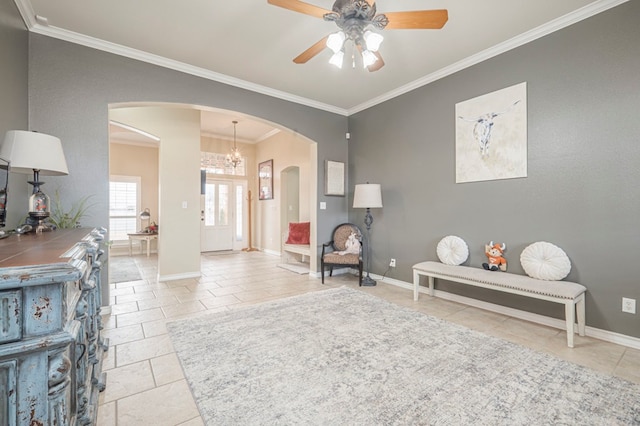 sitting room featuring ceiling fan with notable chandelier and ornamental molding