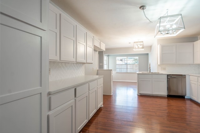 kitchen featuring white cabinets, dark wood finished floors, dishwasher, light countertops, and a sink