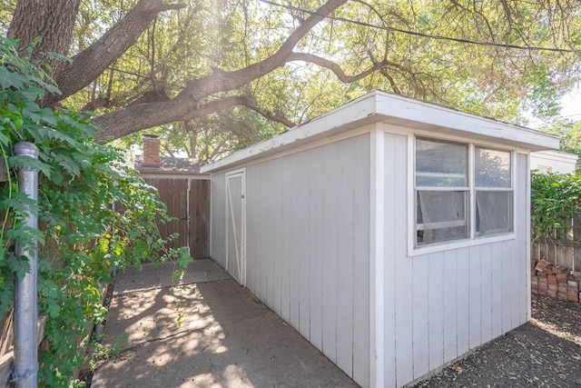 view of outbuilding with an outbuilding and fence