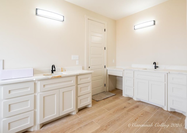 bathroom featuring hardwood / wood-style flooring and vanity