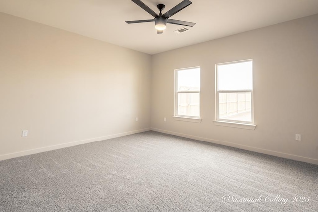 carpeted spare room with ceiling fan