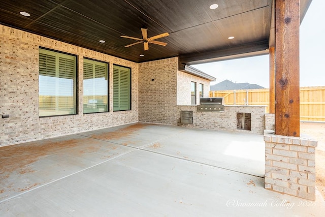 view of patio with area for grilling, grilling area, and ceiling fan