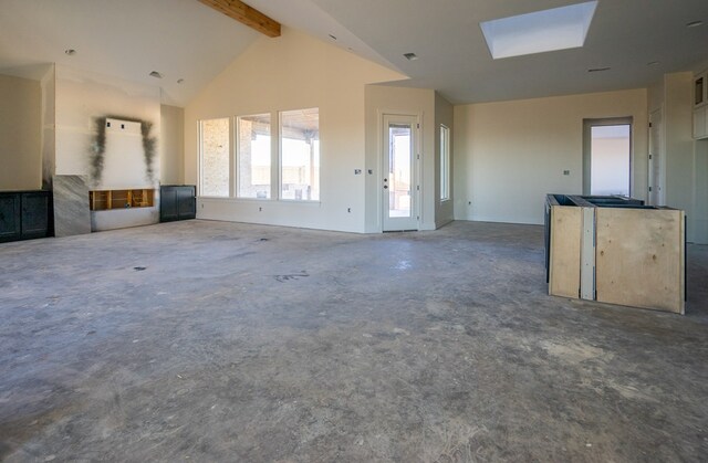 unfurnished living room featuring concrete flooring, high vaulted ceiling, beam ceiling, and a skylight