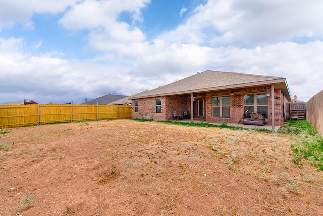 418 Orourke, Midland, TX 79706 - back of property featuring brick siding, a fenced backyard, a patio, and roof with shingles