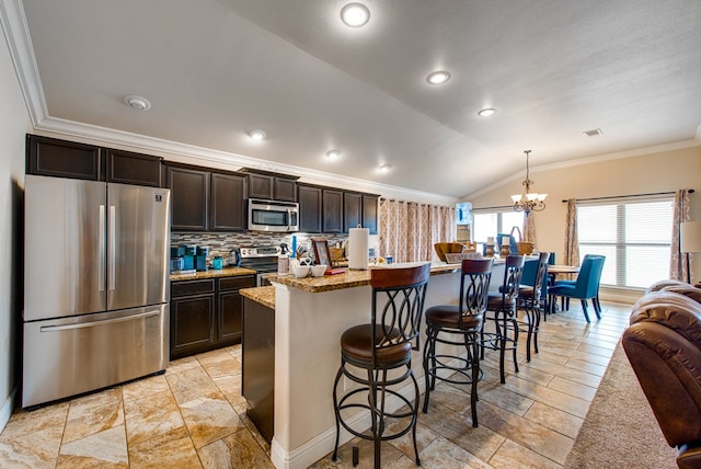 418 Orourke, Midland, TX 79706 - kitchen with stainless steel appliances, ornamental molding, a chandelier, lofted ceiling, and dark brown cabinets