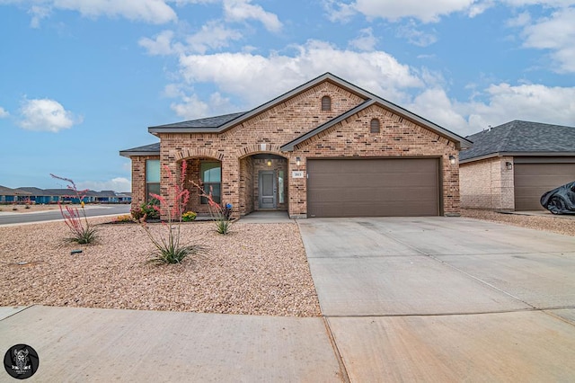 2013 Swenson St, Midland, TX 79705 - view of front of house featuring brick siding, concrete driveway, and an attached garage