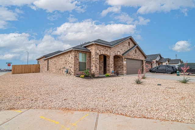 2013 Swenson St, Midland, TX 79705 - view of front of property with brick siding, concrete driveway, an attached garage, and roof with shingles