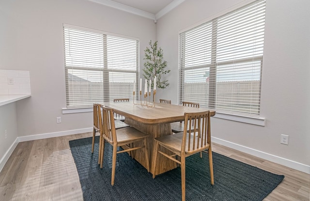 2013 Swenson St, Midland, TX 79705 - dining space featuring light wood-style floors, crown molding, and baseboards