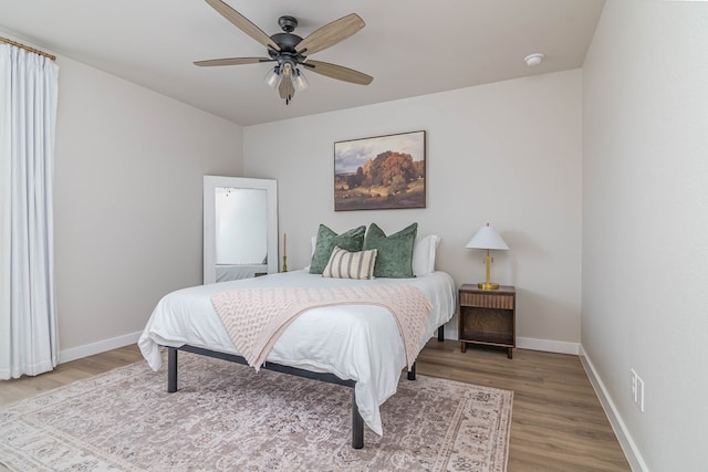 2013 Swenson St, Midland, TX 79705 - bedroom with light wood-style floors, baseboards, and ceiling fan