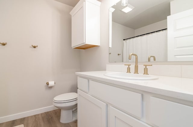 2013 Swenson St, Midland, TX 79705 - full bathroom featuring vanity, wood finished floors, toilet, and baseboards