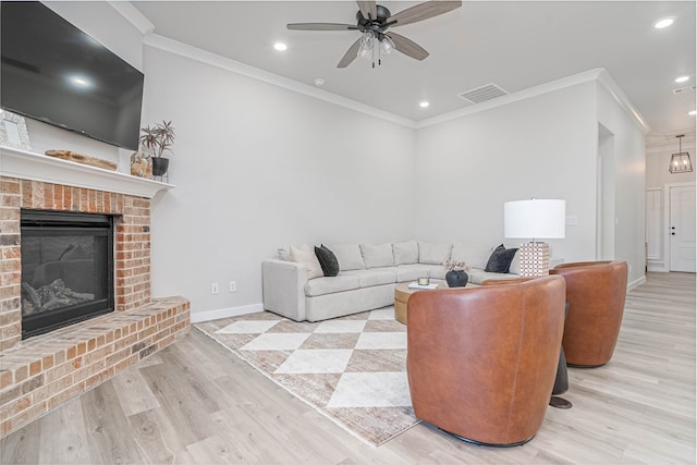 2013 Swenson St, Midland, TX 79705 - living room featuring wood finished floors, ornamental molding, a ceiling fan, a brick fireplace, and baseboards