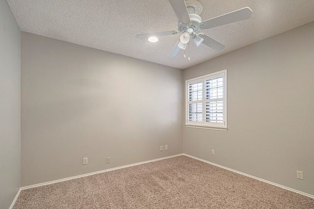 empty room with ceiling fan, carpet floors, and a textured ceiling