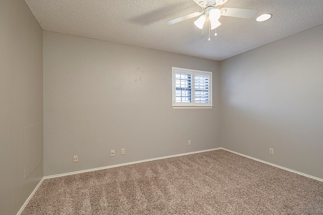 unfurnished room with ceiling fan, carpet floors, and a textured ceiling