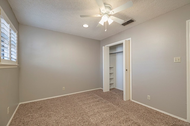 unfurnished bedroom featuring carpet floors, a closet, and ceiling fan