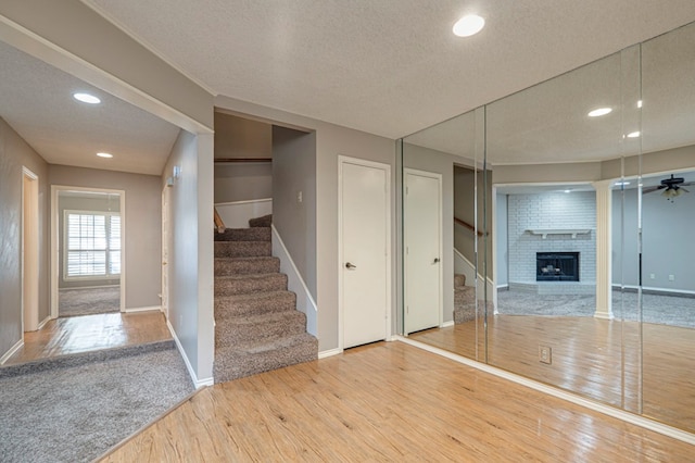 interior space with hardwood / wood-style flooring, a fireplace, and a textured ceiling