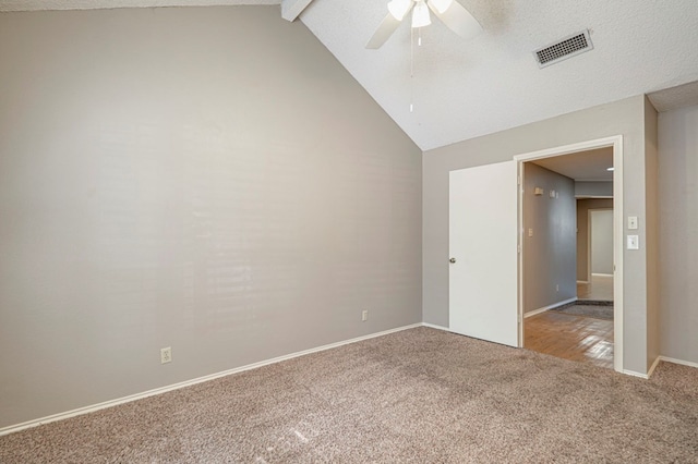 carpeted spare room featuring ceiling fan and lofted ceiling