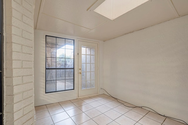 doorway with light tile patterned flooring