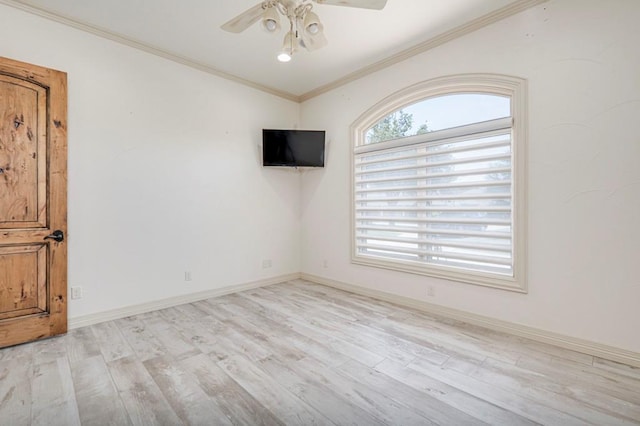 spare room with baseboards, ornamental molding, ceiling fan, and wood finished floors