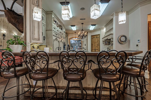 bar featuring dark wood-style flooring, decorative light fixtures, visible vents, and a chandelier