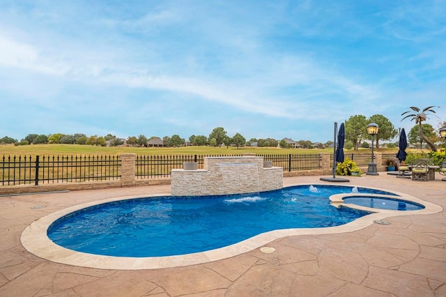 view of pool with a fenced backyard, a patio, and a pool with connected hot tub