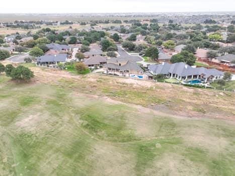 drone / aerial view featuring a residential view and golf course view