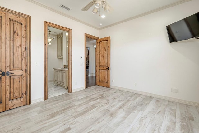 unfurnished bedroom with baseboards, ornamental molding, light wood-style flooring, and visible vents