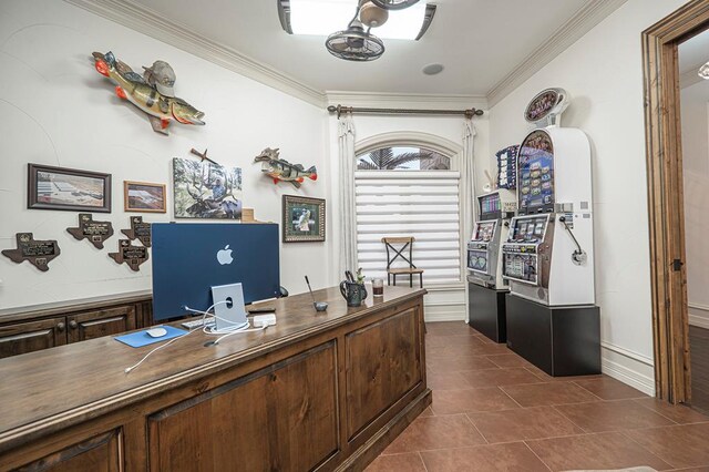 office with crown molding, dark tile patterned flooring, and a ceiling fan