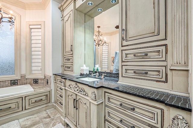 full bathroom with vanity, ornamental molding, a bath, and a chandelier