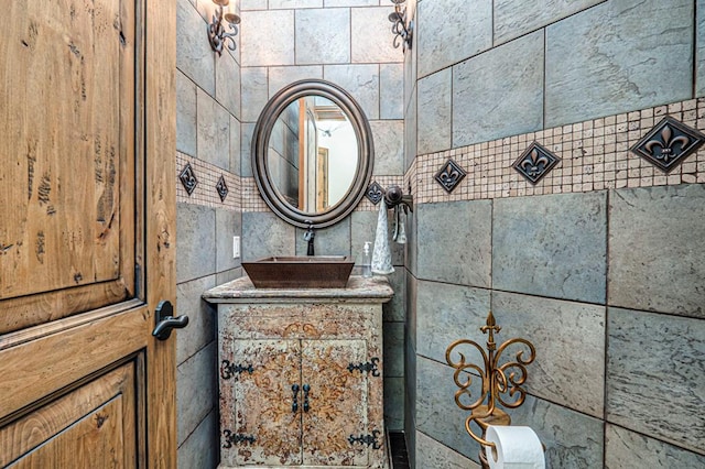bathroom with tile walls and vanity