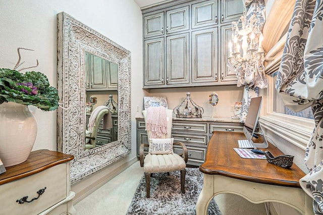 carpeted office featuring a chandelier