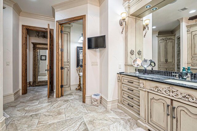 bathroom with visible vents, crown molding, vanity, baseboards, and recessed lighting