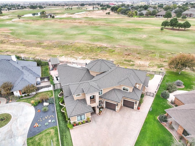 birds eye view of property featuring a water view, view of golf course, and a residential view