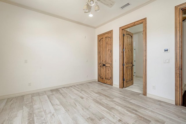 unfurnished bedroom featuring visible vents, baseboards, crown molding, and light wood-type flooring