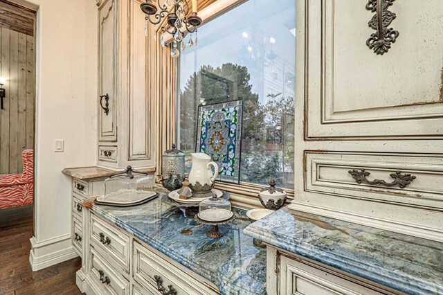 bathroom with baseboards, a chandelier, wood finished floors, and vanity