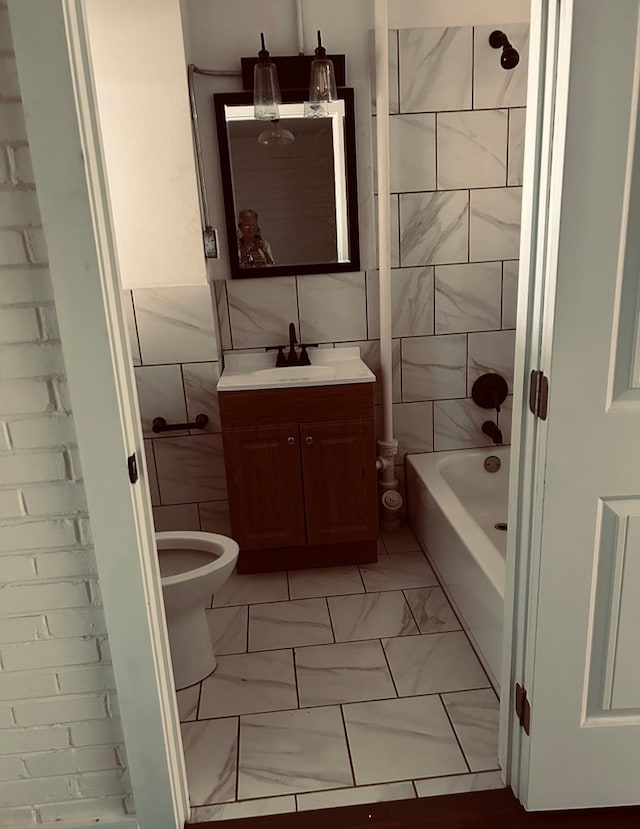 126 Coliseum Dr, Snyder, TX 79549 - bathroom with vanity, tile walls, toilet, marble finish floor, and shower / bathtub combination